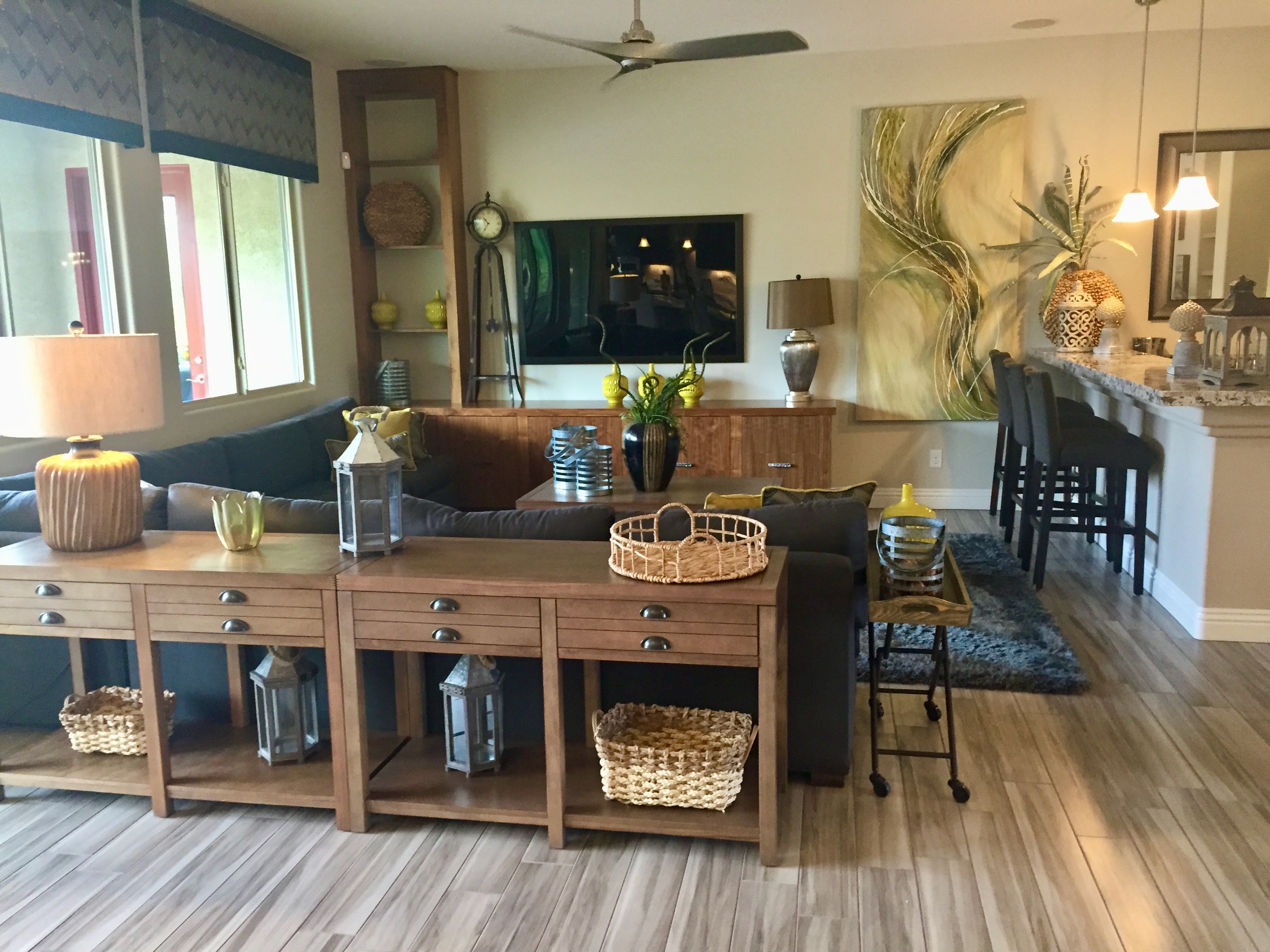 A collected living space with woven baskets, lanterns, ceramic vessels and yellow accents